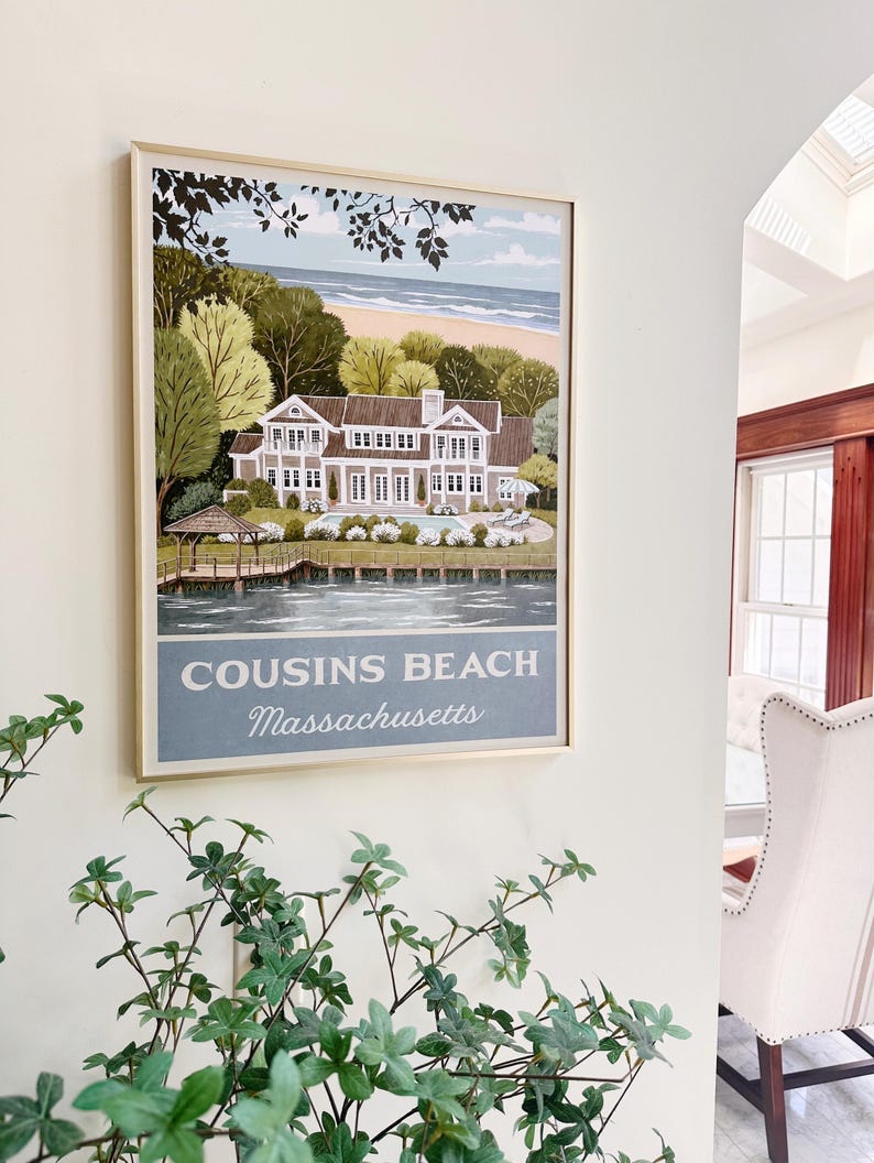 May include: Framed print of Cousins Beach, Massachusetts, featuring a large house, trees, and a beach scene. The print has a light blue and beige color scheme, with the text "Cousins Beach Massachusetts" at the bottom.