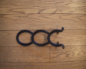 Colt Boot Jack is made from new horseshoes.  14"L x 4 5/8"W x 2 3/4"H.  Color: Flat Black