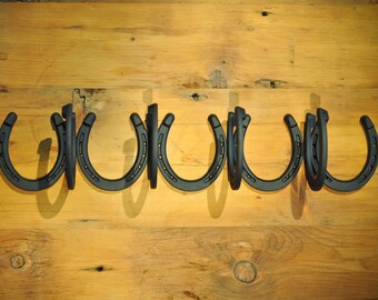 4 Coat Wall Mounted Horseshoe Coat Rack.  23 1/4L x 4 1/2W x 4 3/4H.