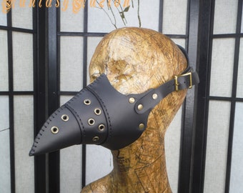 May include: Black leather plague doctor mask with a long beak and brass rivets. The mask is worn on a mannequin head with a brown leather strap.
