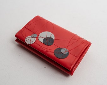 small red purse made of truck tarpaulin with circles