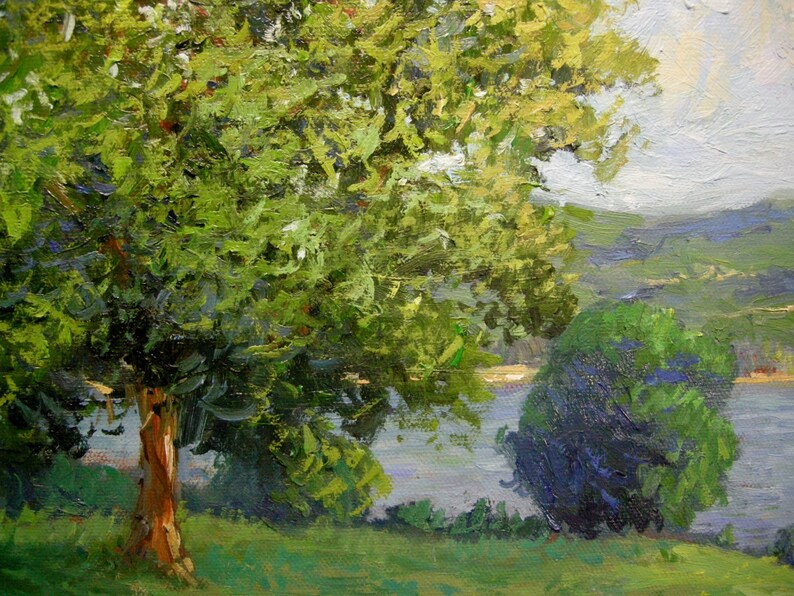 May include: Oil painting landscape depicting a tranquil scene. Lush green foliage dominates the foreground, with a prominent tree exhibiting a textured, reddish-brown trunk.  A smaller, darker green bush is positioned to the right, near a calm body of water. The background features rolling hills under a soft, cloudy sky, painted in muted blues and grays. The overall style is impressionistic, with visible brushstrokes adding texture and depth to the scene.