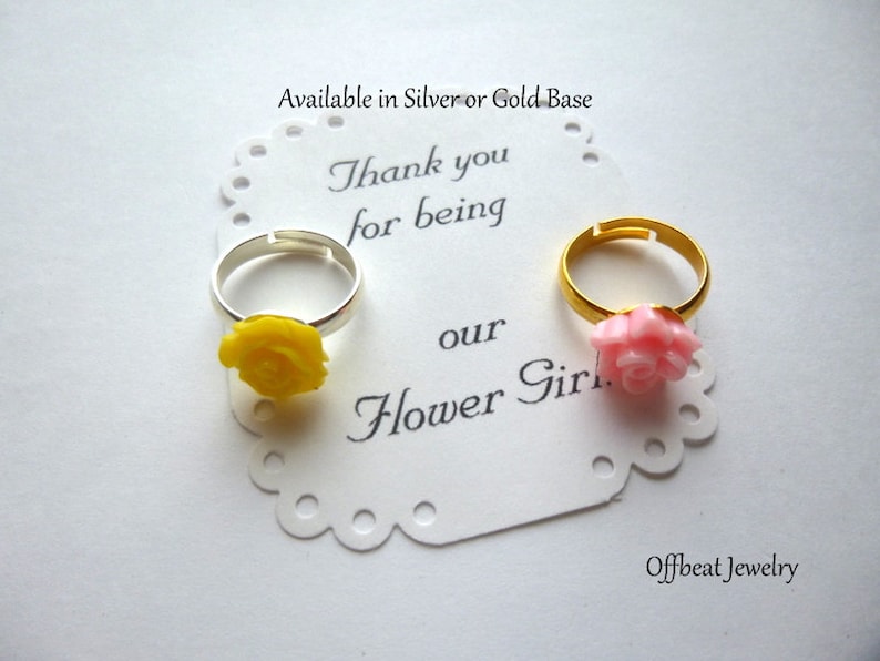 May include: Two flower girl rings with a yellow rose and a pink rose. The rings are available in silver or gold. The card reads "Thank you for being our Flower Girl".