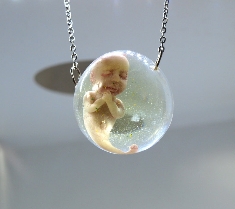 Bizarre contemporary jewelry Sirenomelia mutation Encapsulated baby mermaid pendant Curiosities cabinet fetus sculpture Medical specimen