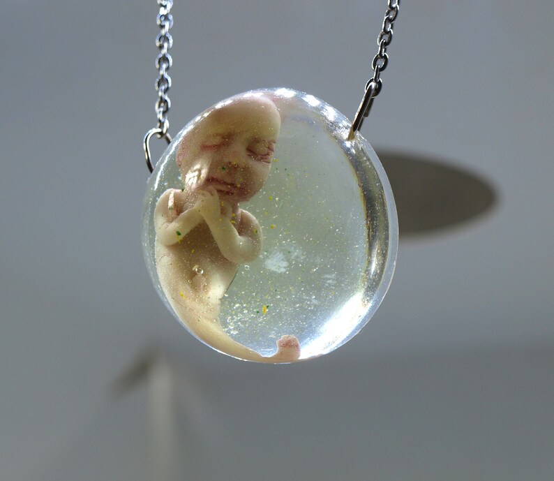 Bizarre contemporary jewelry Sirenomelia mutation Encapsulated baby mermaid pendant Curiosities cabinet fetus sculpture Medical specimen