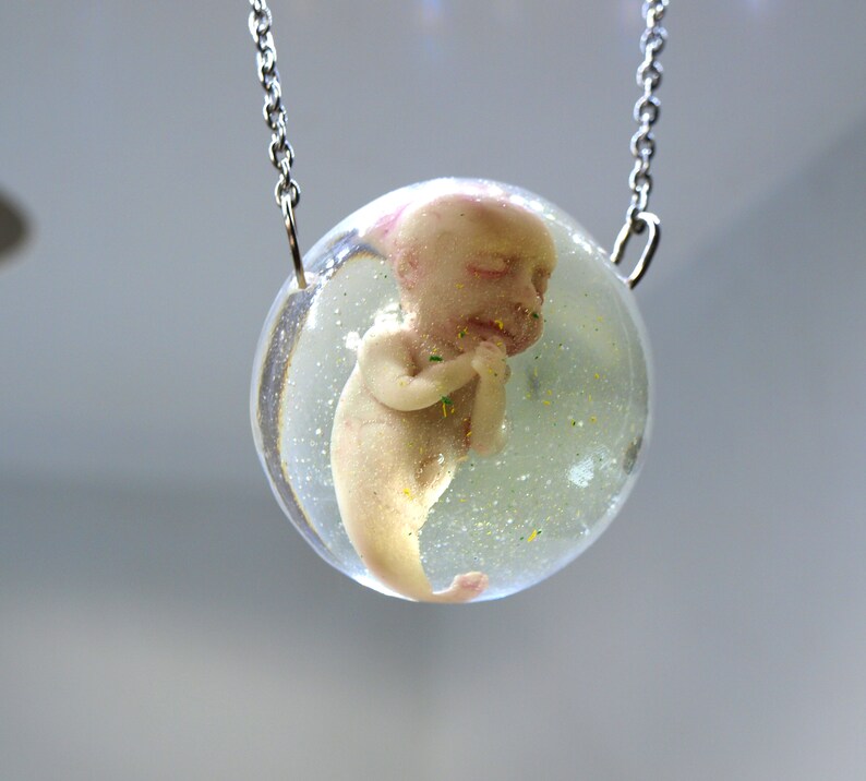 Bizarre contemporary jewelry Sirenomelia mutation Encapsulated baby mermaid pendant Curiosities cabinet fetus sculpture Medical specimen