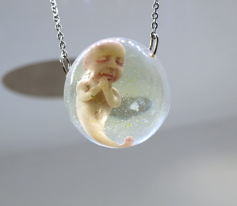 Bizarre contemporary jewelry Sirenomelia mutation Encapsulated baby mermaid pendant Curiosities cabinet fetus sculpture Medical specimen
