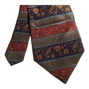May include: A patterned silk tie with a brown, blue, and red striped background. The tie features a gold floral design.