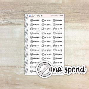 May include: A sheet of stickers with a no spend theme. The stickers are white with black text and a black circle with a diagonal line through it. The text on the stickers says "no spend".