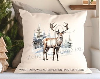 May include: A white throw pillow featuring a watercolour illustration of a deer standing in a snowy forest. The text "stone home co." is printed in the bottom right corner of the pillow.
