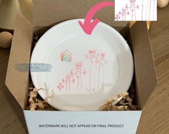 May include: A white ceramic dish with a child's drawing of a family with a rainbow. The dish is in a white box with the text "WATERMARK WILL NOT APPEAR ON FINAL PRODUCT".