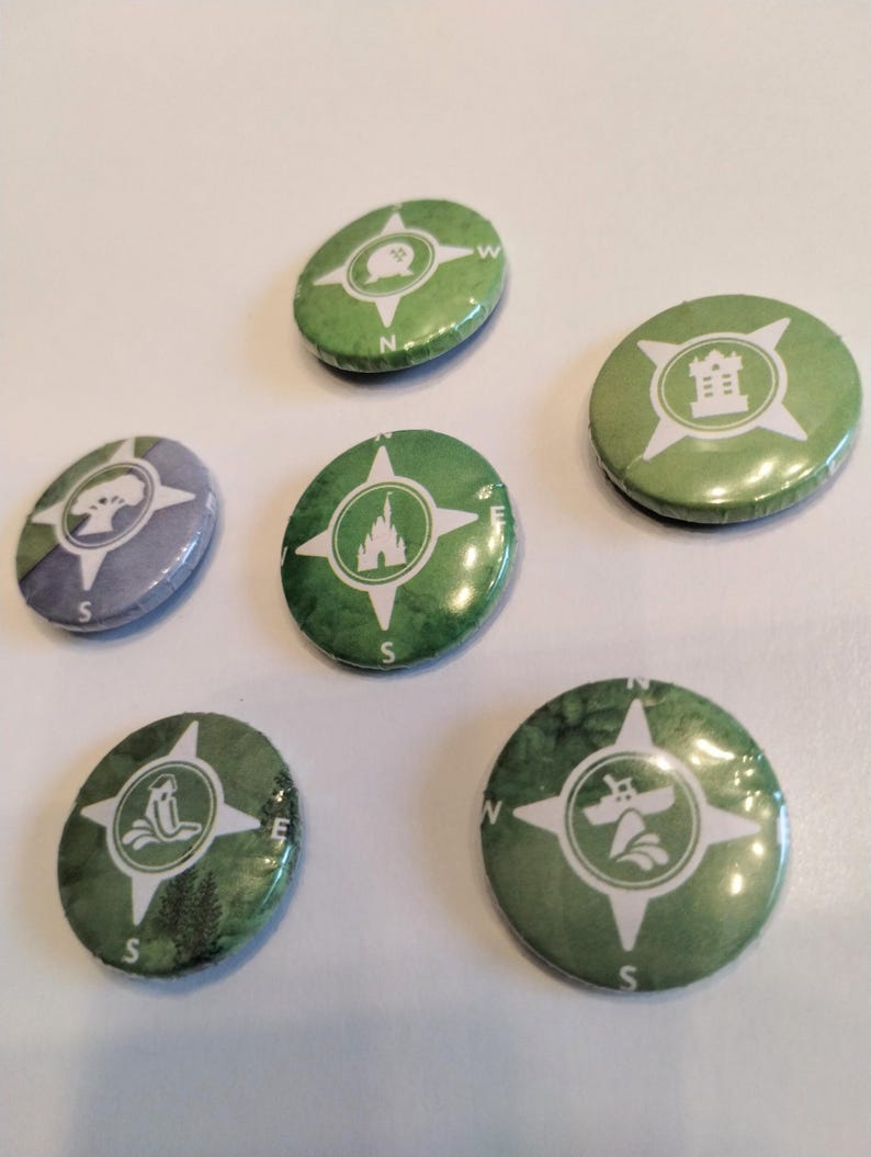 May include: Six green and white compass-shaped buttons with different icons. The icons include a castle, a tree, a boat, a castle, a tree, and a building.
