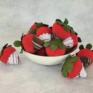 Two strawberry catnip toys.