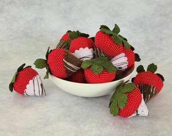 Two strawberry catnip toys.