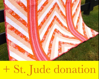 May include: A quilt with a chevron pattern in shades of orange, pink, and white. The quilt is hanging on a black fence. + St. Jude donation