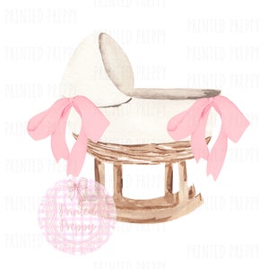 May include: Watercolor illustration of a baby cradle. The cradle is white with a wicker base and wooden rocking legs. Pink ribbons adorn the sides. The text "Printed Preppy" is in a pink circle at the bottom.