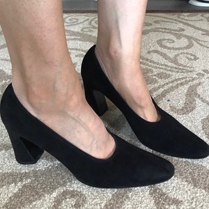 Peut inclure: Une paire de chaussures &agrave; talons en daim noir avec un talon bloc.