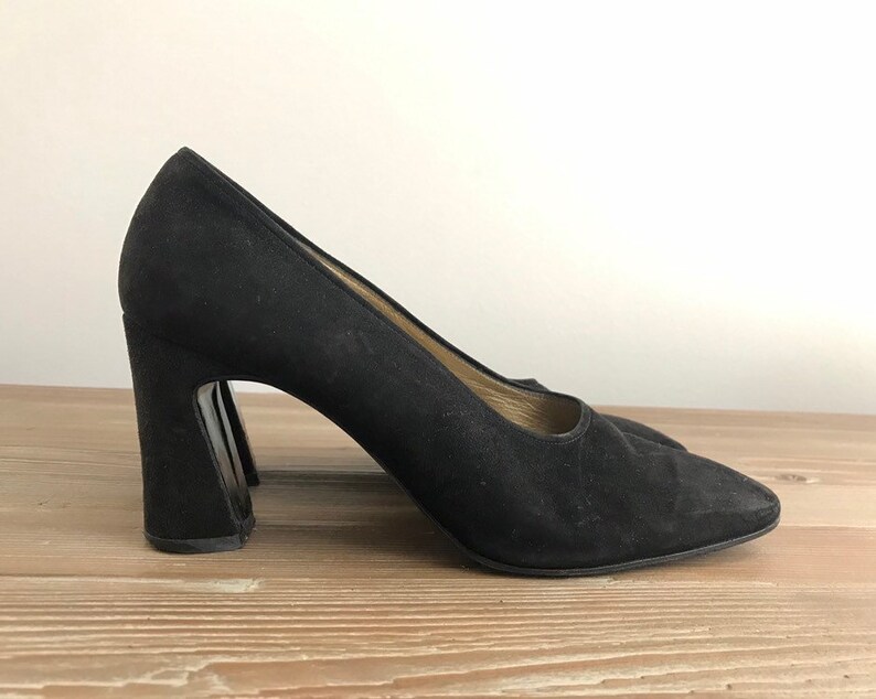 Peut inclure: Pumps en daim noir avec un talon bloc &eacute;pais.