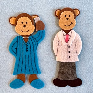 May include: Two felt monkey puppets. One monkey is wearing a blue and white striped pajamas and the other is wearing a white coat with a pink tie and gray pants.