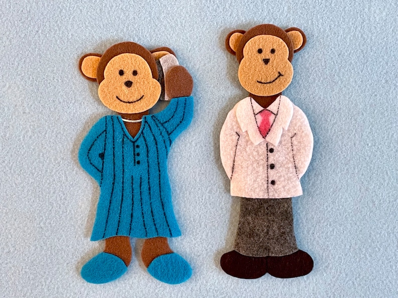 May include: Two felt monkey puppets. One monkey is wearing a blue and white striped pajamas and the other is wearing a white coat with a pink tie and gray pants.
