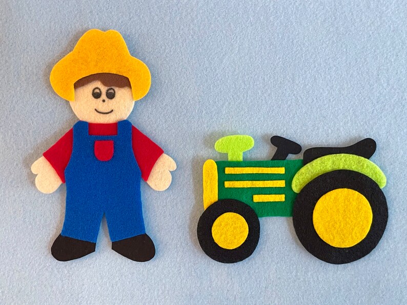 May include: A felt toy set featuring a farmer wearing a yellow hat and blue overalls, and a green tractor with yellow wheels.