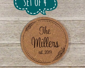 May include: Set of four cork coasters with a brown background and black text. The coasters feature a feather design and the text "The Millers est. 2019".