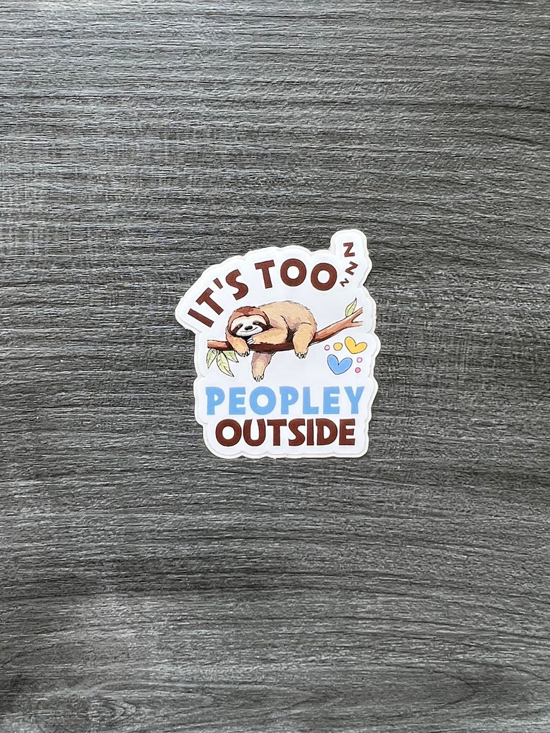 May include: A white sticker with a brown sloth sleeping on a branch with the text "It's too ZZZ" and "People outside".
