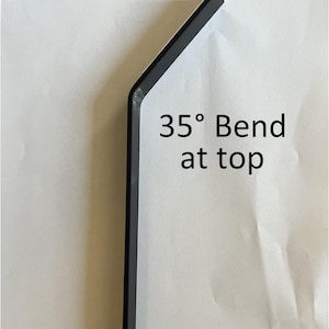 May include: A black, angled metal tool with a 35-degree bend at the top. The tool is positioned against a white background, showcasing its shape and design. The text "35&deg; Bend at top" is visible.