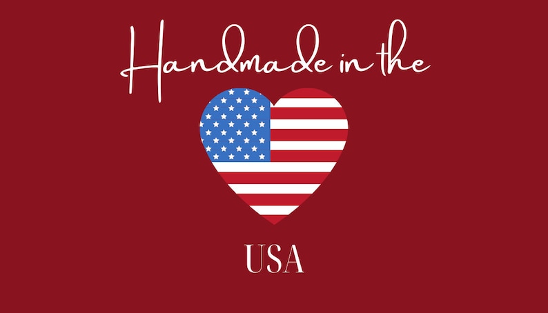 May include: A red background with the text "Handmade in the USA" in white script. A heart-shaped design features the American flag, with blue stars and red and white stripes.