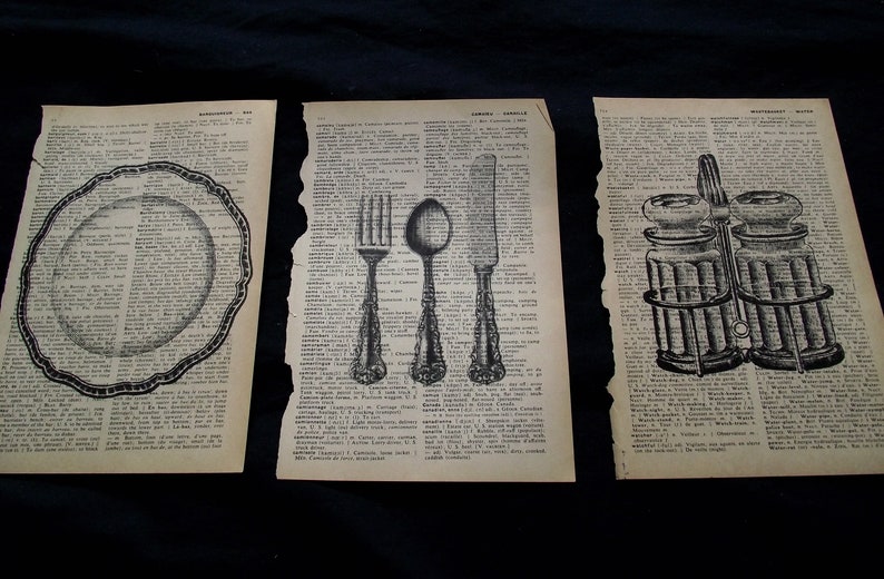May include: Three vintage dictionary pages featuring black ink illustrations. The left page shows a scalloped plate, the center page displays a fork, spoon, and knife, and the right page depicts a pair of glass salt and pepper shakers in a metal holder.