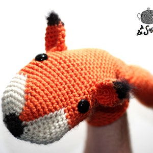 May include: Orange and white crocheted fox puppet with black eyes and nose.