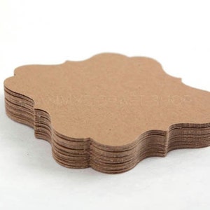 May include: A stack of brown, scalloped, blank gift tags. The tags are made of a textured paper.