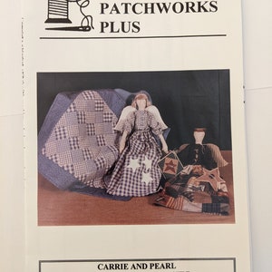May include: A quilt pattern for folk art angels and a doll quilt. The pattern is called "Carrie and Pearl" and is from Patchworks Plus, issue PP-24. The image shows two dolls dressed in blue and white gingham fabric with white stars.