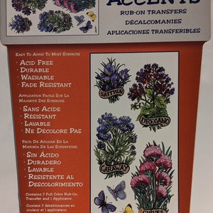 May include: A package of seven full-color rub-on transfers featuring illustrations of various herbs, including saffron, oregano, caraway, and chives. The package includes one applicator and is acid-free, durable, washable, and fade-resistant.  The text "Indoor/Outdoor Accents" is printed on the package.