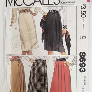 May include: A sewing pattern for four different skirts. The skirts are in various colors and patterns, including beige, black, brown, and black and white checkered. The pattern is for a miss size, extra small.