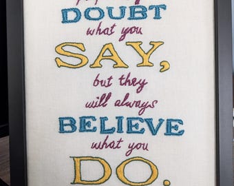 Embroidered quote 'people may doubt what you say, but they will always believe what you do'