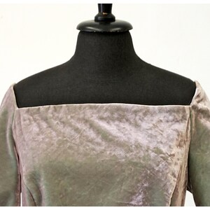 May include: A mauve velvet dress with a square neckline and short sleeves.