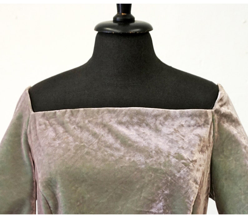 May include: A mauve velvet dress with a square neckline and short sleeves.