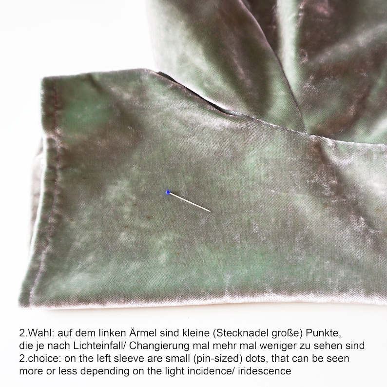 May include: A close-up of a light green velvet fabric with small pin-sized dots. The dots are visible depending on the light incidence or iridescence. 2.Wahl: auf dem linken &Auml;rmel sind kleine (Stecknadel gro&szlig;e) Punkte, die je nach Lichteinfall/ Changierung mal mehr mal weniger zu sehen sind 2.choice: on the left sleeve are small (pin-sized) dots, that can be seen more or less depending on the light incidence/ iridescence