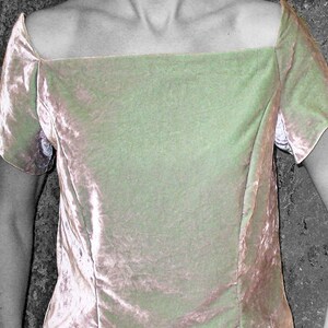 May include: A light pink velvet top with a square neckline and short sleeves.