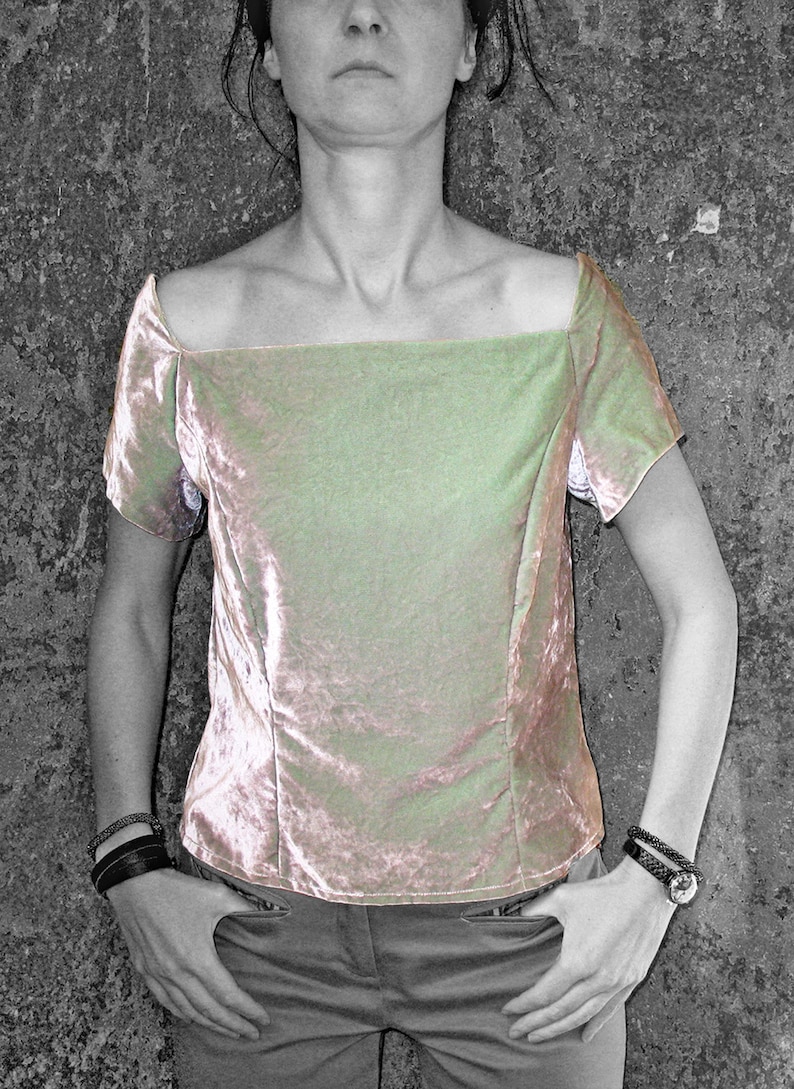 May include: A light green velvet top with a square neckline and short sleeves. The top is fitted and has a slightly cropped length.