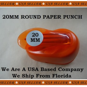May include: Orange plastic 20mm round paper punch. The punch has a white label with black text that reads "20 MM".