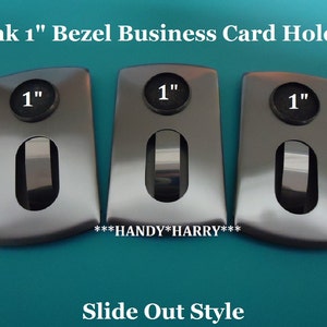 May include: Three silver business card holders with a 1-inch opening for cards. The holders are labeled "1" and have a slide-out style. The text "***HANDY*HARRY***" is printed below the holders.