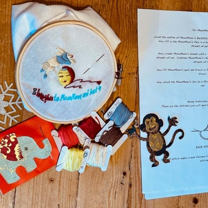 May include: A craft kit for making a felt MoonMan. The kit includes a hoop with felt, embroidery floss, and instructions. The instructions include a diagram of a monkey and the text "Bunny Embroidery Stitches".