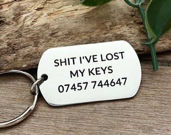 May include: Silver key chain with a silver tag that reads "SHIT I'VE LOST MY KEYS 07457 744647"