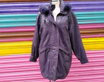 May include: A purple leather jacket with a fur-lined hood. The jacket has a zipper closure, two pockets, and a drawstring waist.