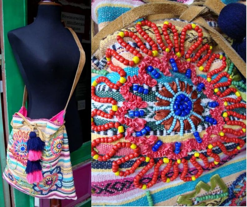 May include: A colorful woven bag with a drawstring closure and a long strap. The bag is decorated with embroidered flowers and beads in shades of red, blue, yellow, and pink.