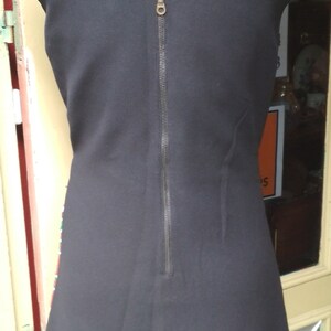 May include: A black sleeveless dress with a zipper down the back.