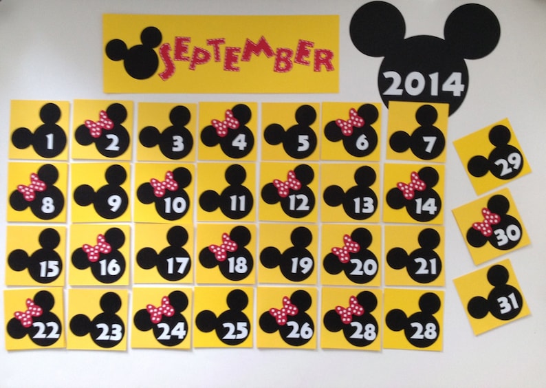 May include: A yellow and black Mickey Mouse themed calendar for September 2014. Each day is represented by a square with a black Mickey Mouse head and a red bow. The numbers 1 through 31 are printed on the squares.