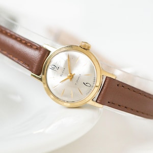 Vintage SLAVA Ladies Watch: Gold Plated, Arabic Numerals, Leather Strap